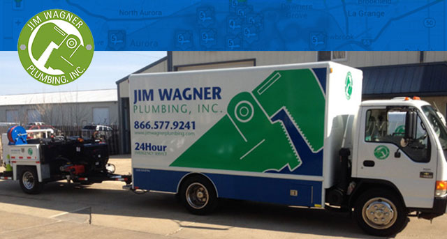 Jim Wagner Plumbing, Inc. service truck with logo and contact information, parked outside a building, symbolizing reliable plumbing services in Naperville, IL.